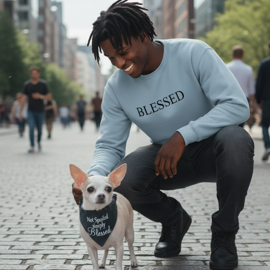 Man in 'BLESSED' sweatshirt with a small dog wearing a Not spoiled simply blessed bandana