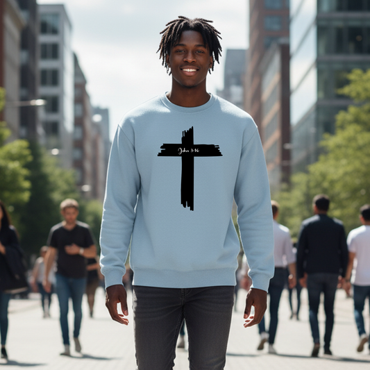 Man wearing a light blue sweatshirt with a black cross design in an urban setting