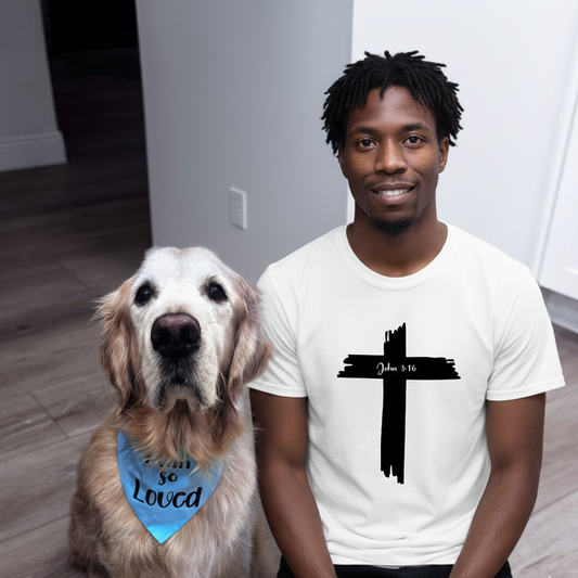 Man wearing a white t-shirt with a black cross design, sitting next to a dog wearing a bandana that says I am so Loved